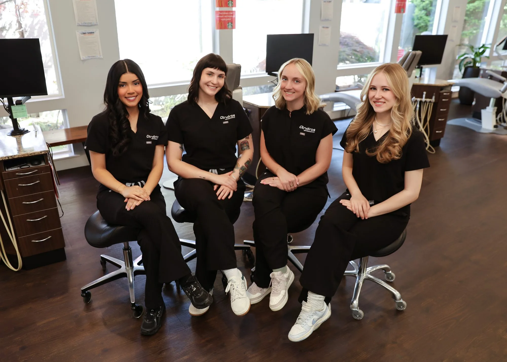 Andros Orthodontics clinical team seated in the treatment bay